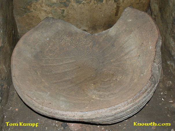 Basin stone ornamented with arcs and rays